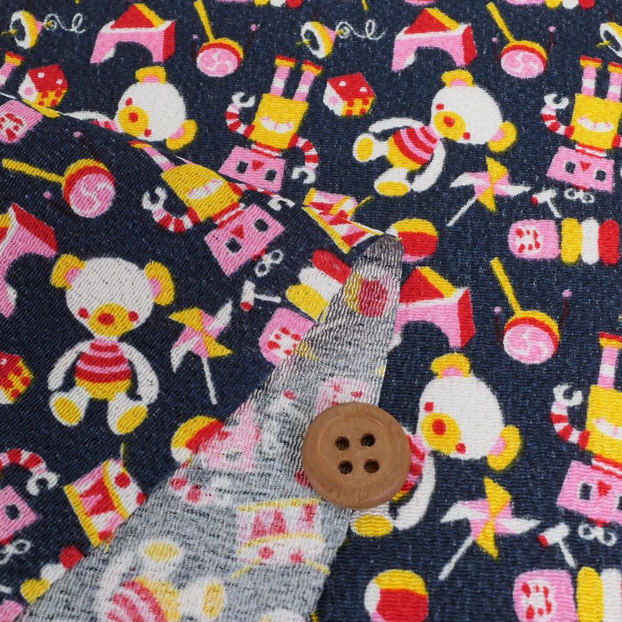 ちりめん生地 おもちゃのパレード(紺) 10cm単位 切り売り