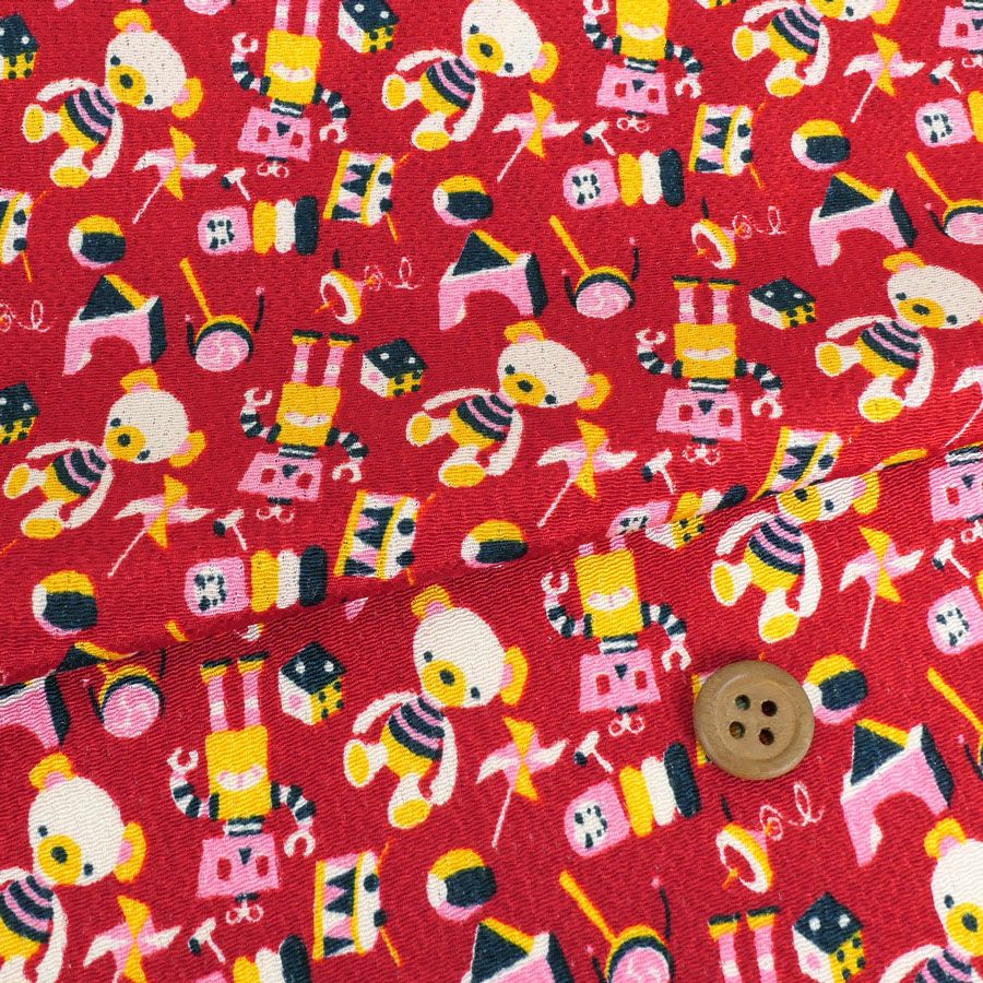 ちりめん生地 おもちゃのパレード(赤) 10cm単位 切り売り