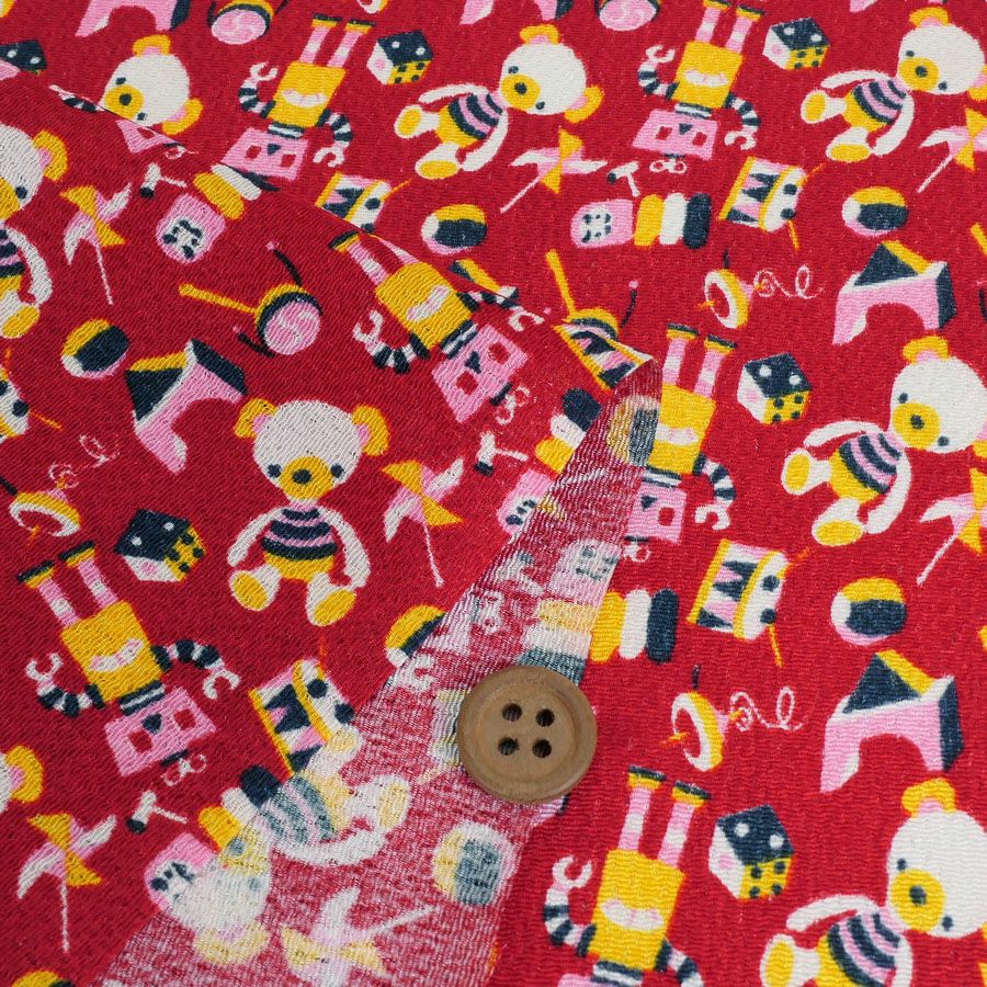 ちりめん生地 おもちゃのパレード(赤) 10cm単位 切り売り