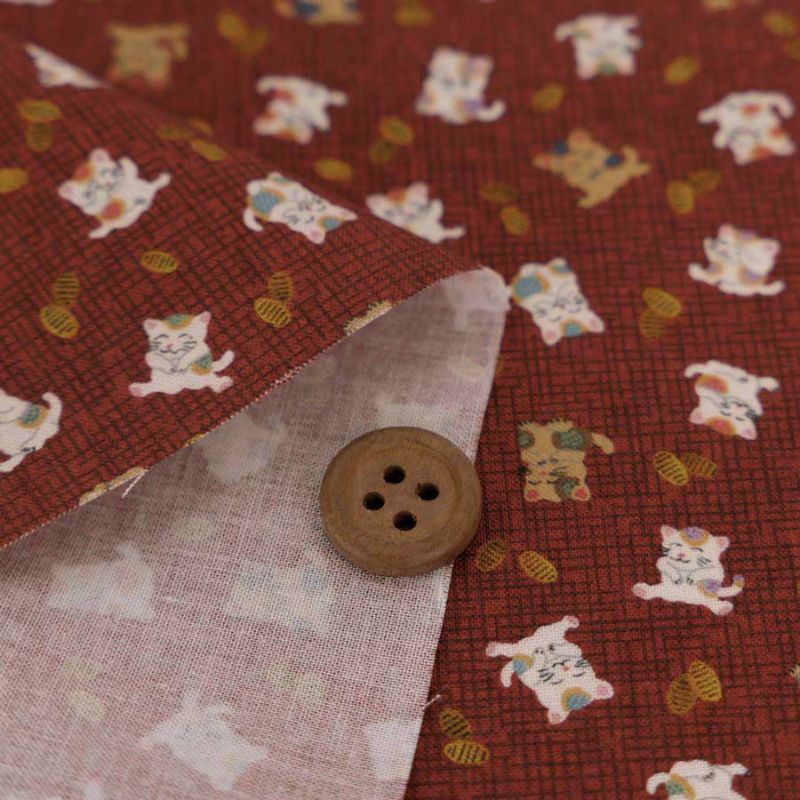 和柄コットン生地 招き猫に小判(れんが色) 10cm単位 切り売り